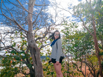 Woman standing on tree