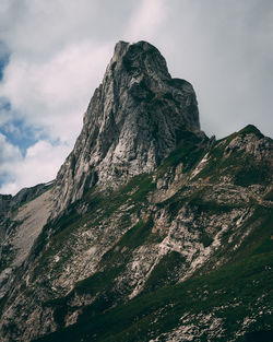 Low angle view of rocky mountain against sky