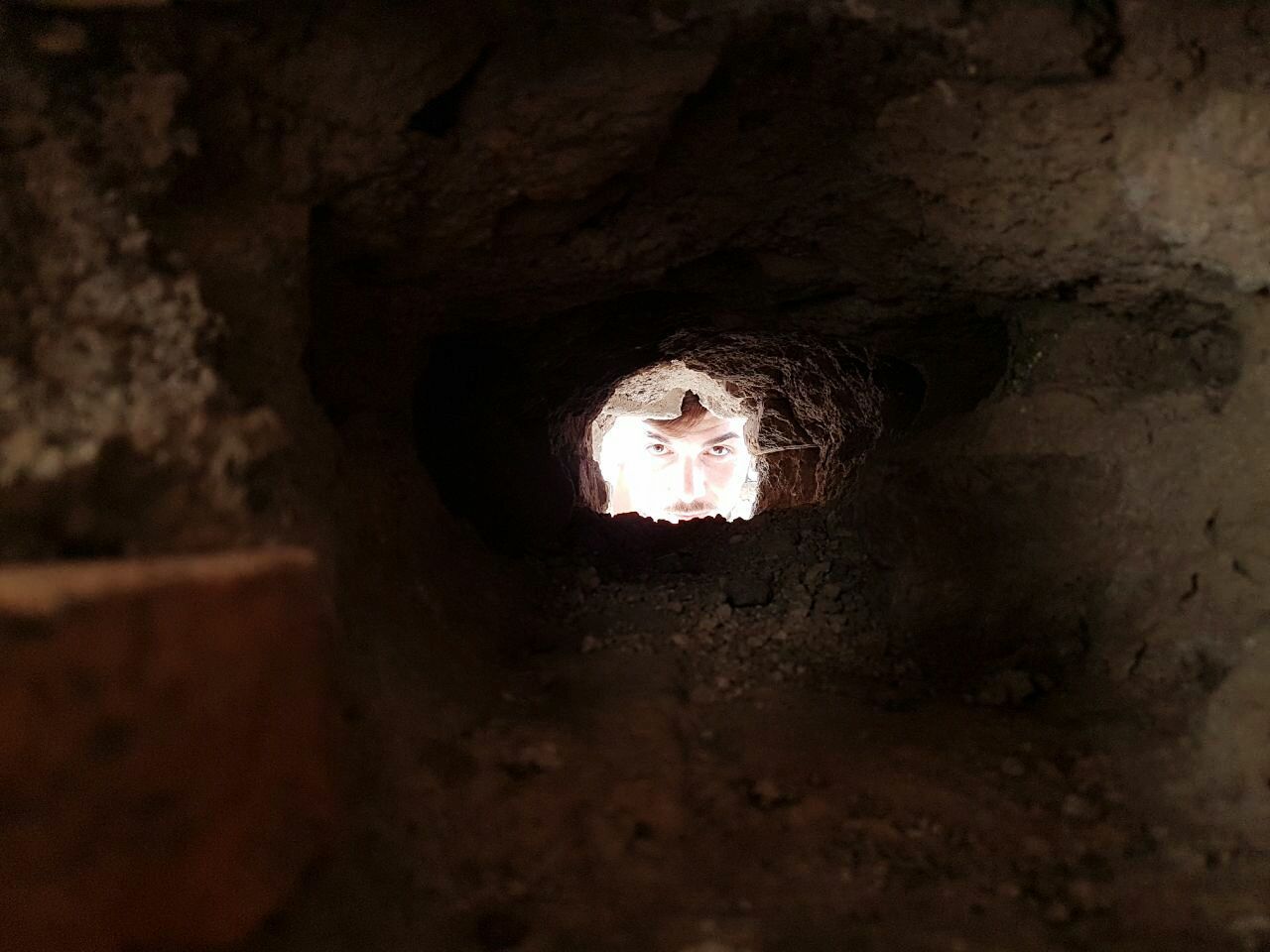 ILLUMINATED TUNNEL SEEN FROM CAVE