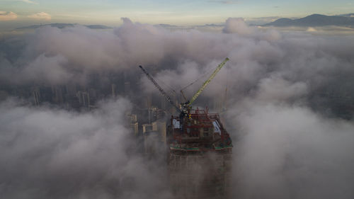 Cranes against sky