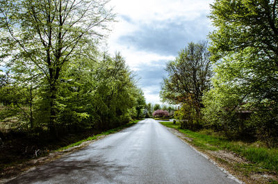 Road amidst trees against sky