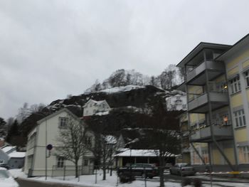 Houses against sky during winter