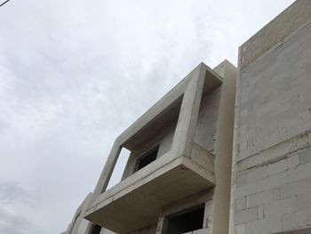 Exterior of modern building against cloudy sky