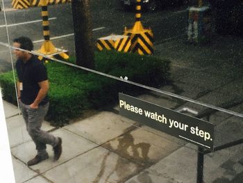 Reflection of man on road