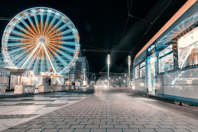 Illuminated ferris wheel at night