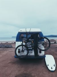 Bicycle on beach against sky