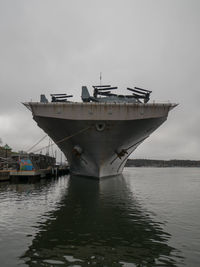 Ship moored in sea against sky
