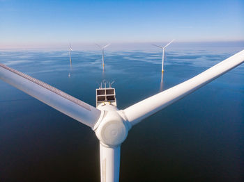 Low angle view of windmill against sky