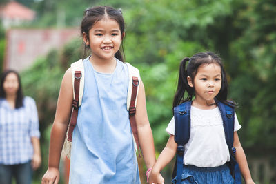 Smiling girls standing outdoors