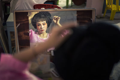 Portrait of woman holding girl at home