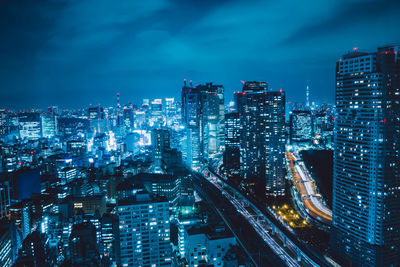 High angle view of illuminated city buildings at night