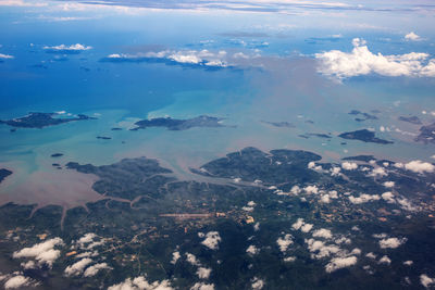 High angle view of sea and landscape against sky