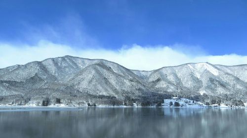 Scenic view of lake against cloudy sky