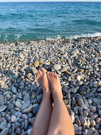 Personal perspective female legs relaxing by the sea