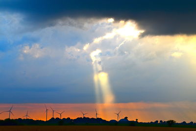 Silhouette of wind turbines at sunset