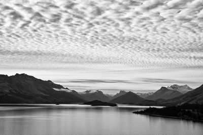 Scenic view of lake and mountains against sky