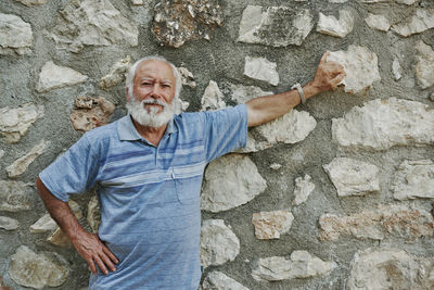 Portrait of a smiling young man against wall