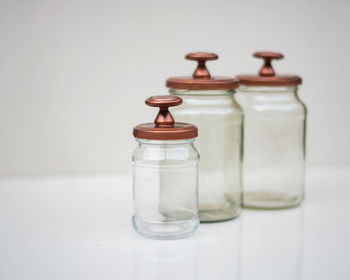 Close-up of glasses on table against white background