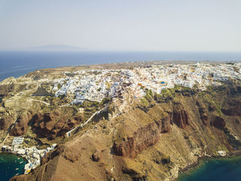 Aerial view of landscape and sea against clear sky