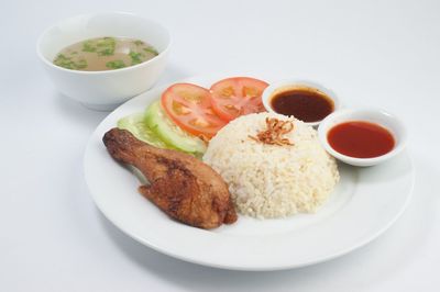 Fried chicken served with steamed rice and salad