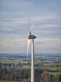 Windmill on field against sky