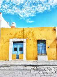 Exterior of yellow building against sky