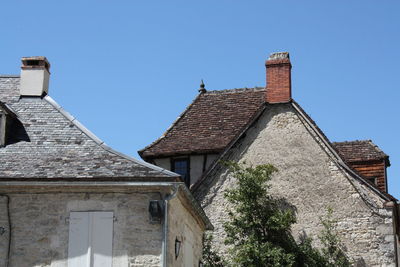 Low angle view of built structure against clear blue sky