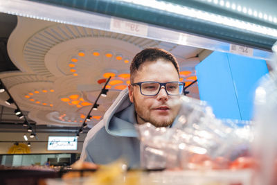 Portrait of young man standing in laboratory