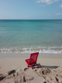 Chair on shore at beach