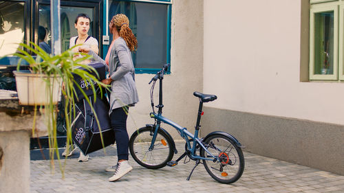 Low section of man riding bicycle on street