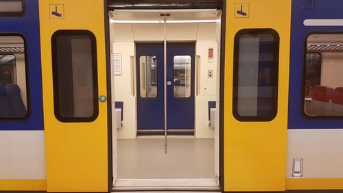 Open yellow door of train