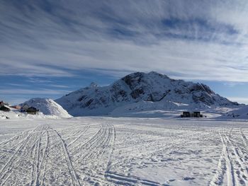 Scenic view of snow covered mountains against sky