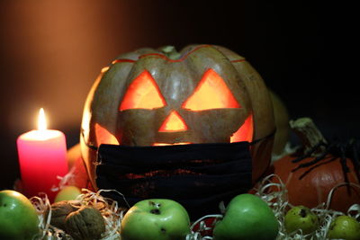 Close-up of illuminated pumpkin against black background