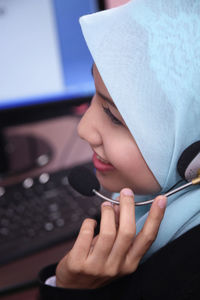 Female customer service representative using computer in office