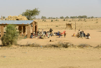 People on field against clear sky