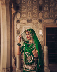 Woman standing against wall