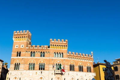 Low angle view of building against blue sky