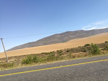 Road on mountain against clear sky