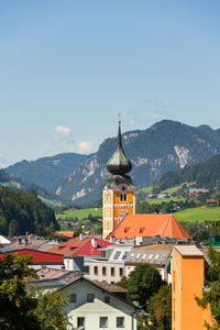 Buildings in town against sky