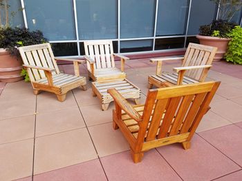 Empty wooden chairs outside building