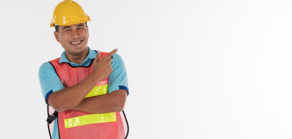 Portrait of smiling man standing against white background