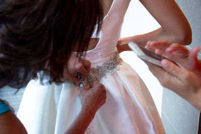 Midsection of woman using mobile phone