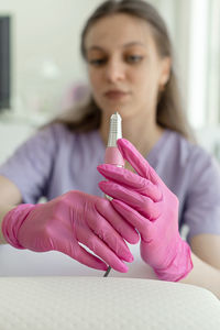 Midsection of woman holding dentures