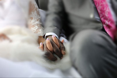 Bride and groom holding hands.