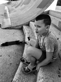 Smiling cute boy sitting on steps