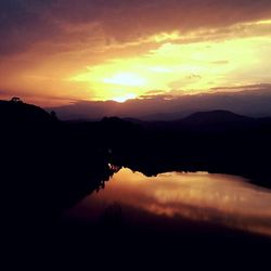 Scenic view of lake at sunset