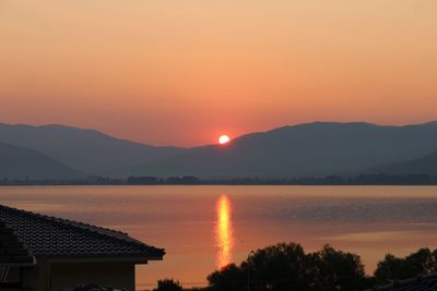 Scenic view of lake against romantic sky at sunset