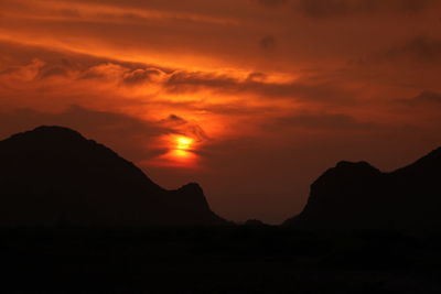 Scenic view of silhouette mountains against sky during sunset