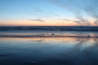 Scenic view of beach against sky during sunset