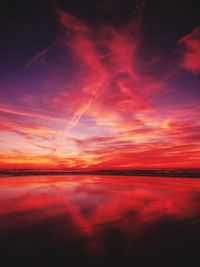 Scenic view of dramatic sky over sea during sunset